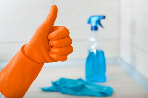 Technician checking cleaning product safety and ventilation