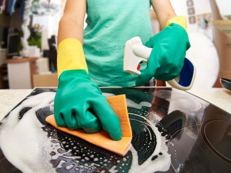 Technician assessing carpet cleaning safety on a residential floor