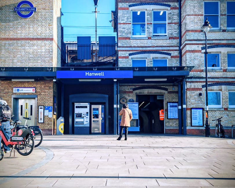Street view of a commercial area on Hampstead High Street showing a red and black restaurant called Angrid Thai with an illuminated 'Open' sign, a standee displaying menu items in front of the entranc